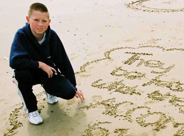 Image of boy on a normandy beach clcik ot go to the poem, School Trip
